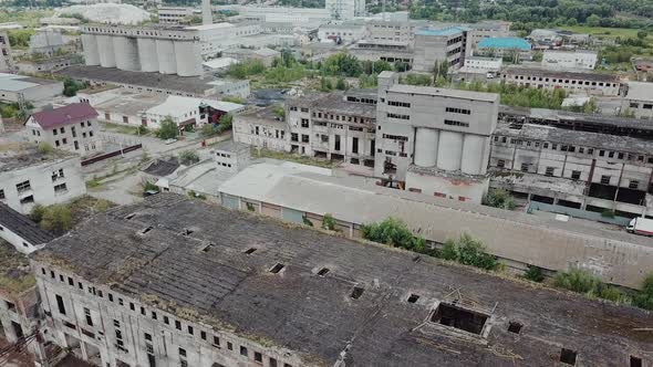 Flight over the destroyed factory. Old industrial building for demolition. Aerial view