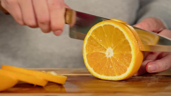 Woman Cutting Oranges Closeup