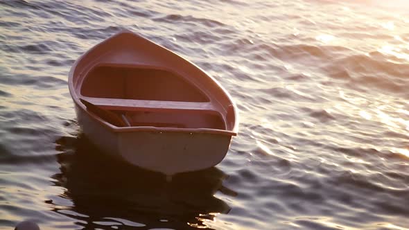 Boat on Waves in Sunset Rays