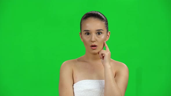 Brilliant Idea Comes To a Woman with Bare Shoulders in White Towel, Wow on Green Screen at Studio