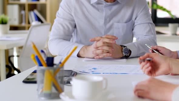 Business Team with Charts at Office Meeting