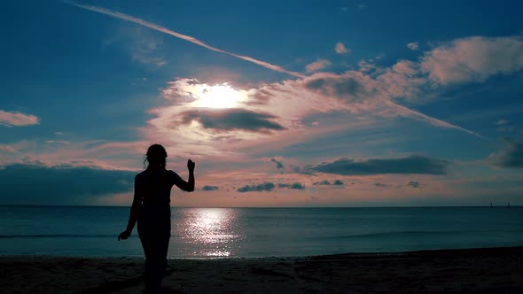 Happy Woman Is Walking and Dancing on Empty Wild Beach with Picturesque Sea View, Silhouette