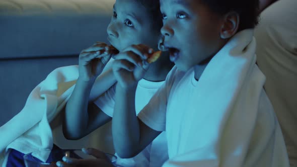 Two Little Black Boys Brothers Sitting on the Floor and Watching TV