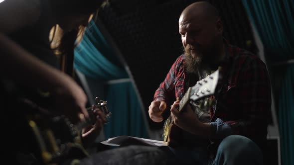 Young Beautiful Girl in Lesson with Experienced Guitarist in Studio