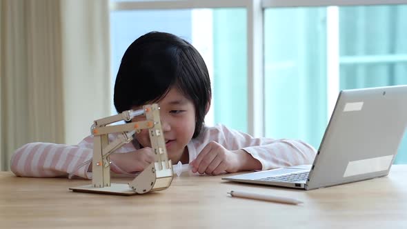 Asian Child Playing Diy Excavator Crane