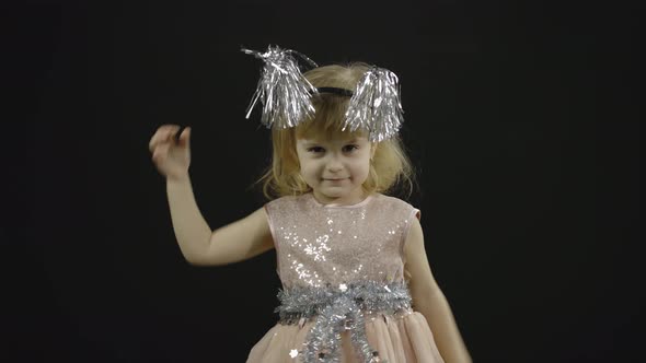Happy Beautiful Little Baby Girl in Glossy Dress. Christmas. Make Faces, Dance