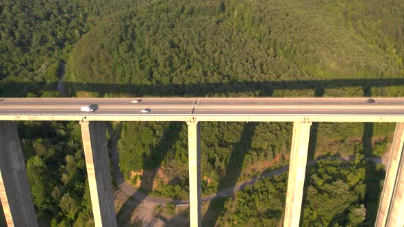 Aerial View of Highway Viaduct on Concrete Pillars with Traffic in the Mountains