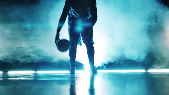 A Man is Practicing to Juggle a Basketball