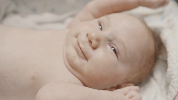 A Little Cute Baby Lying in Bed Before Sleep