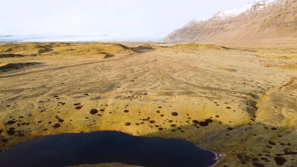 Aerial Flight Over Iceland Magical Volcanic Landscape with Yellow Moss From a Bird'seye View