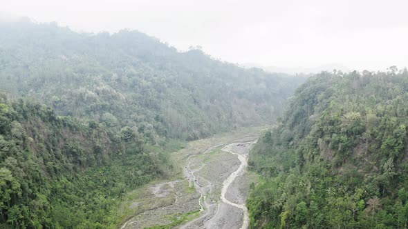 Drone Over Braided River In Gorge Of Dense Forest
