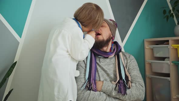 Father and Child Playing Clinic and Doctor Little Boy Dentist in Medical Gown with Stethoscope