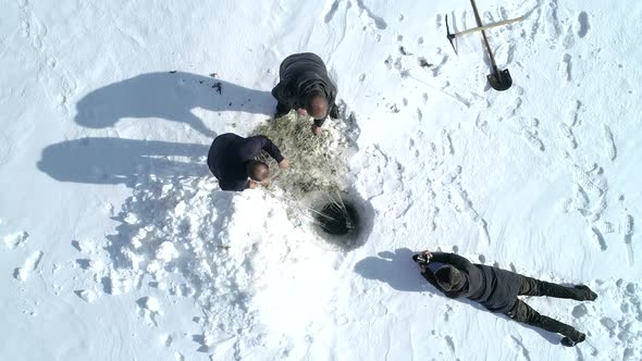 Winter Fishing on Frozen Lake and Photographer