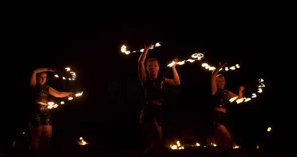 Slow Motion Professional Fire Performance Three Women with Torches and a Man with Flamethrowers