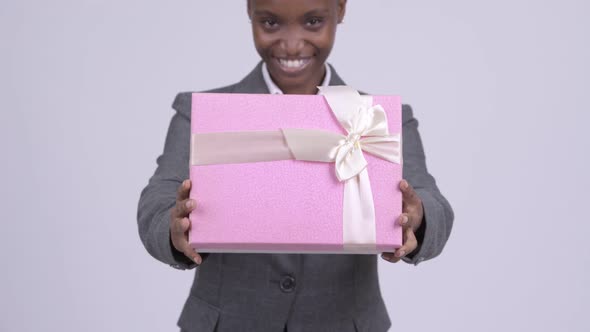 Young Happy African Businesswoman Giving Gift Box