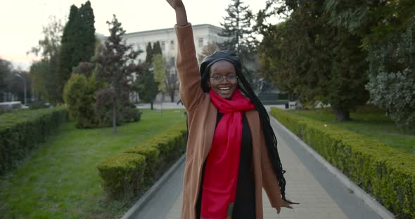 Young Black Girl Jumps From Happiness on the Alley