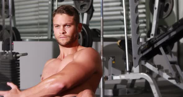 Fit man doing twist exercise at crossfit gym