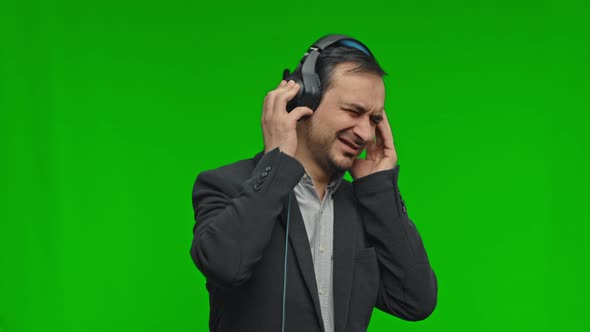 Cheerful Attractive Man Listening Music Via Headphones and Dancing Disco Fooling Around Having Fun