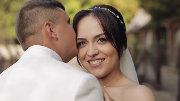 Newlyweds Caucasian Groom with Bride Walking Embracing Hugs in Park Wedding Couple in Love