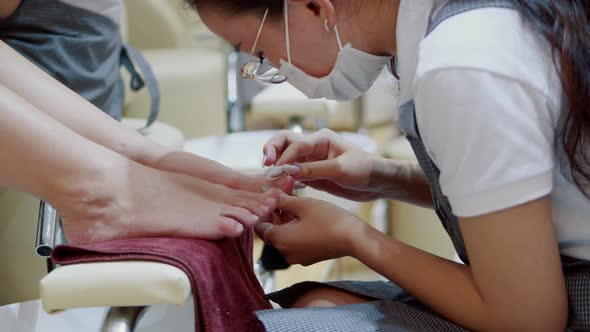 The Beautician Performs the Procedure Prepares and Processes the Client's Nail with a Special
