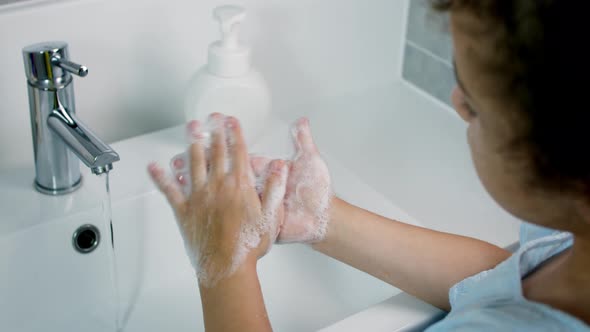 A Child Washes Hands with Soap Little Girl Hands Washing to Prevention Diffusion of Virus and