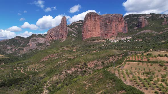 Huge steep orange mountain walls in the mountainous landscape of Huesca in Spain on a beautiful blue