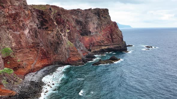 Drone flight next to eroded towering coastal cliffs of Madeira, Portugal