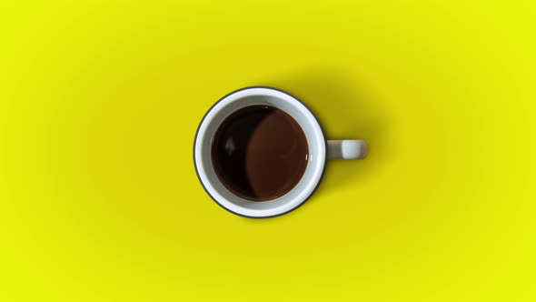 Coffee Fills the Cup in Stop Motion on a Yellow Background