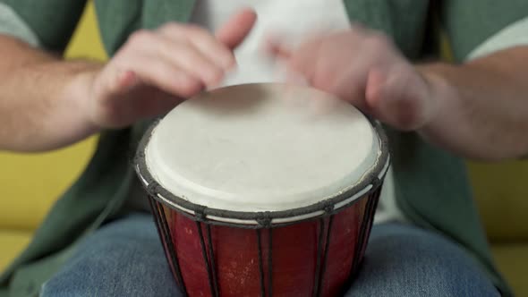 Male Hands Tapping Djembe Bongo in Rhythm