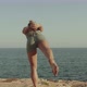 Blond Young Caucasian Girl Practicing Yoga on a Cliff in Front of the Sea - VideoHive Item for Sale