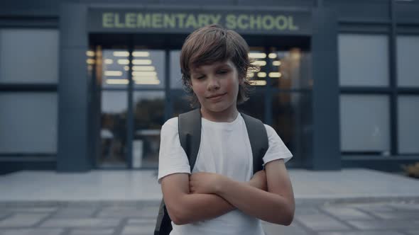 Closeup Cute School Boy Standing with Hands Crossed