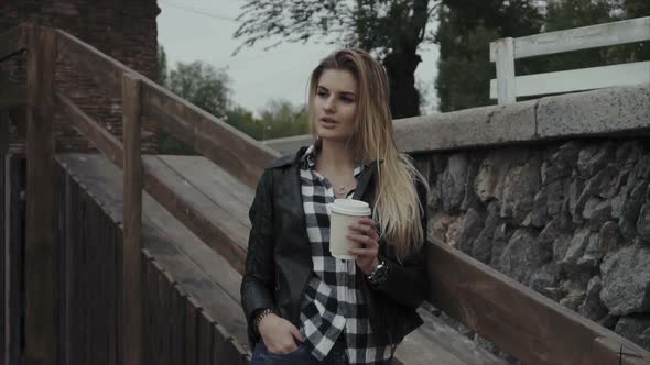 Pretty Woman with a Cup of Coffee Outdoor