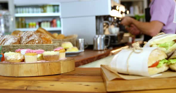 Waitress arranging sandwiches on counter