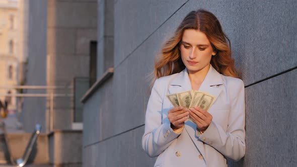 Successful Rich Caucasian Millennial Business Woman Standing on Street City Outdoors Counting Money