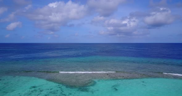 Luxury above tourism shot of a summer white paradise sand beach and turquoise sea background in 4K