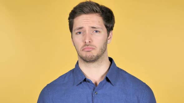 No Disliking Casual Young Man on Yellow Background