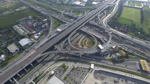 Aerial View of Highway Road Interchange with Busy Urban Traffic Speeding on Road