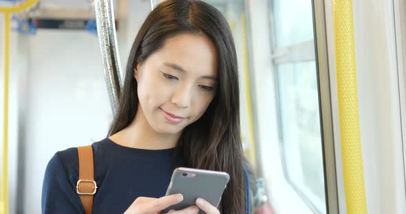 Travel Woman using cellphone in train compartment