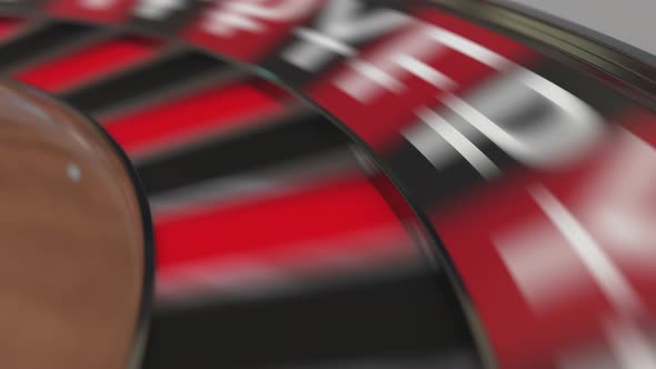 Ball in Pound Sterling Sign Pocket on Casino Roulette Wheel alt