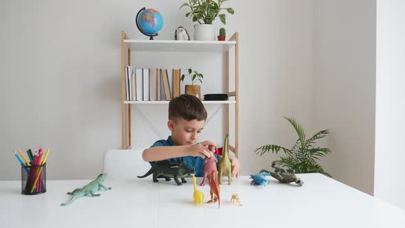 Funny Kid Playing with Dinosaurs at Home