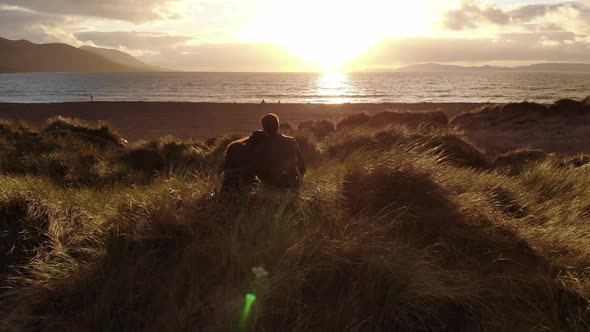 Young Couple in Love on the Beach at Sunset