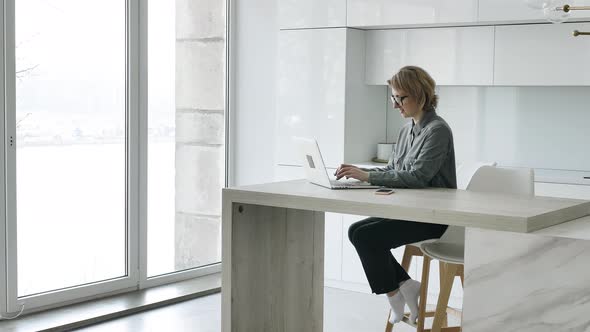 Professional Businesswoman with Short Hair Types on Laptop