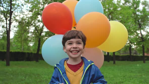 Ecstatic Little Boy with Balloons