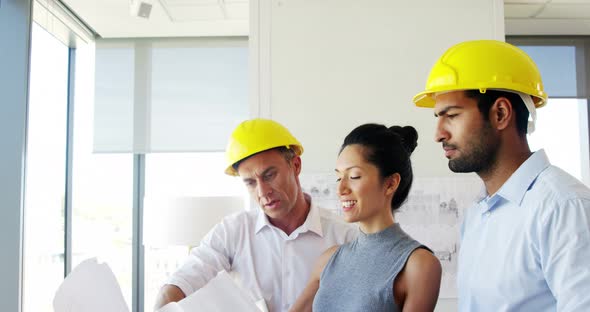 Architects discussing blueprint in a modern office 