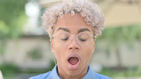 Face Close Up of Young African Woman Looking Shocked at Camera