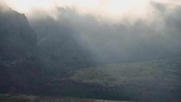 Sunlit Clouds And Mist Moving Over Mountains