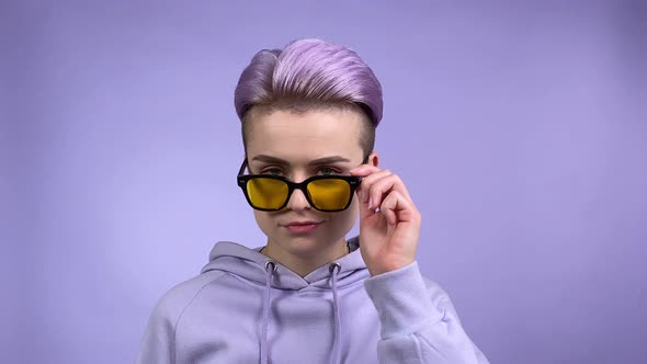 Isolated Portrait of Nonbinary Person in Eyeglasses on Monochrome