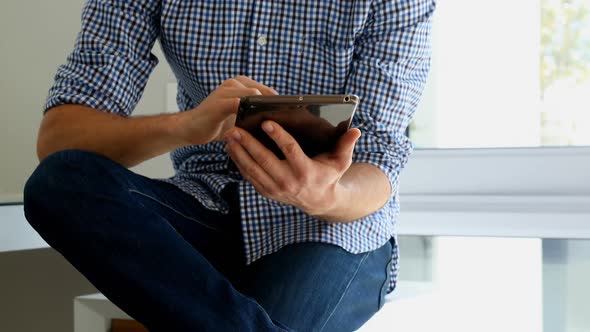 Man using digital tablet at home 