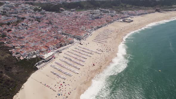 Coastal city of Nazare, Silver coast, Portugal. Beautiful sand beach and refreshing Atlantic Ocean