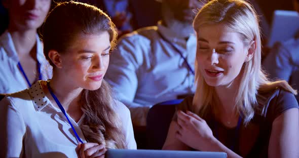 Caucasian businesswomen working on laptop during seminar in auditorium 4k